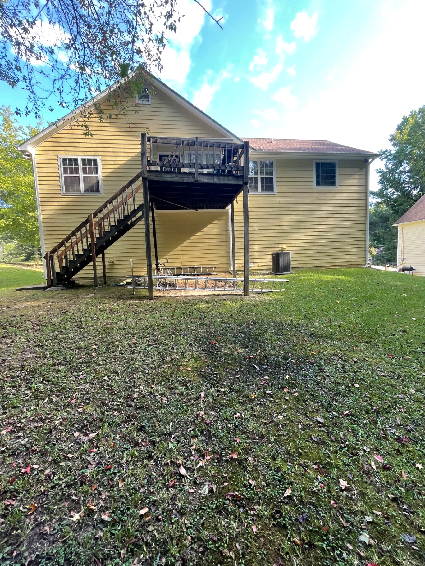 Elevated rear wood deck and staircase refinished by RJM Contracting